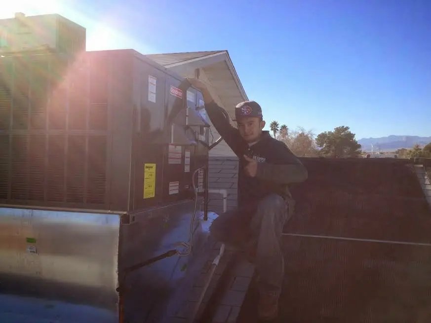 HVAC technician performing AC Tune-Up on a rooftop unit in Buena Park